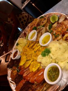 Family Platter with mixed Argentinian Grilled Meat, Seafood, Tostones, Potatoes, Chimchurri Sauce and more.